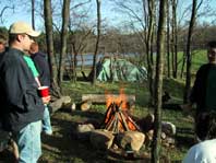 Friends gathered around a campfire in their fire ring